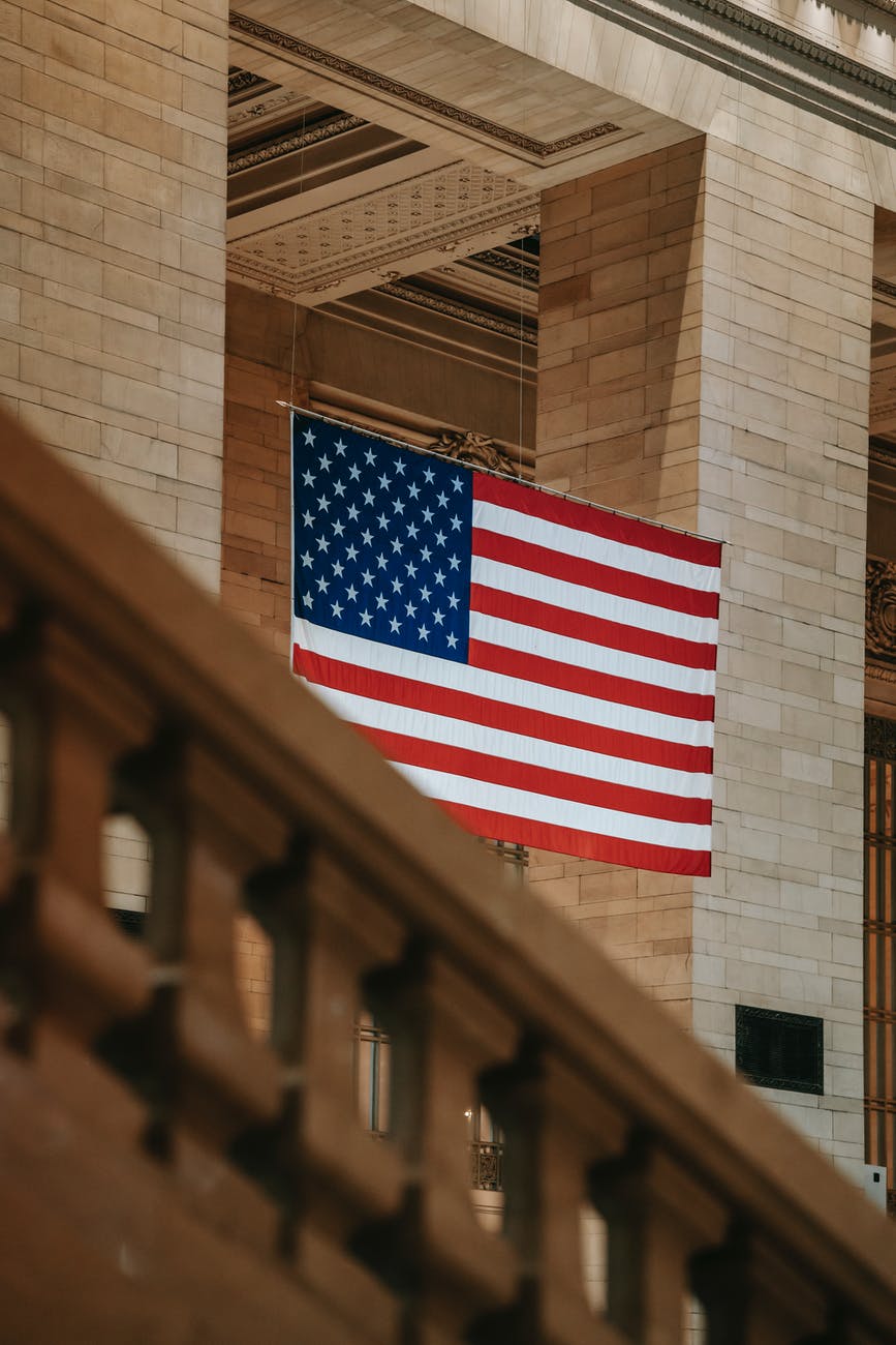 american flag between columns in building